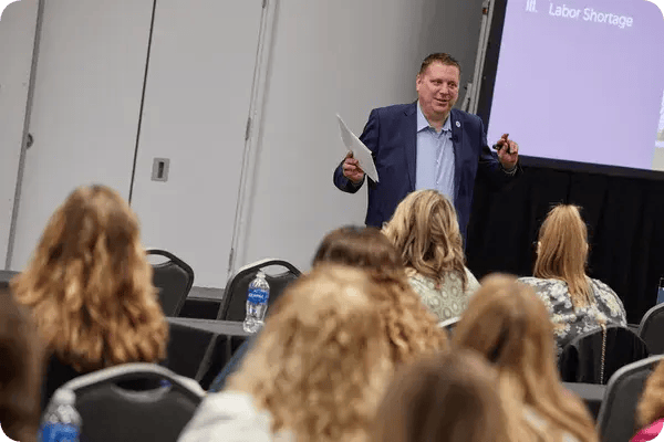A male speaker leads a breakout session at a conference