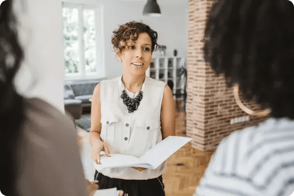 A woman with curly hair presenting a sponsorship proposal