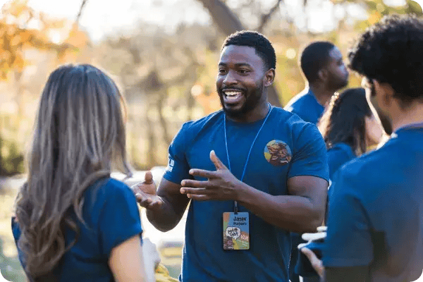 A fundraising event team member speaks with a donor