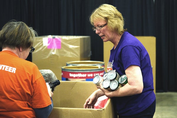 pc/nametag team members sort canned goods for Second Harvest Foodbank