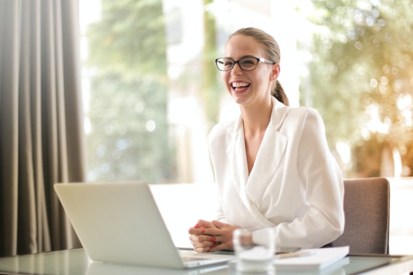 happy remote employee engaged at her work laptop