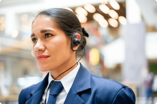 a female event security guard patrols an expo hall