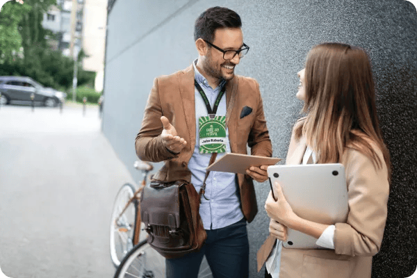 an event professional wears a pcnametag eco event badge with an organic cotton lanyard