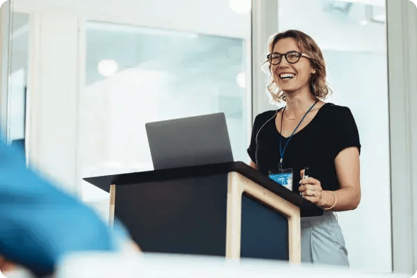A Caucasian female speaker presents to an association