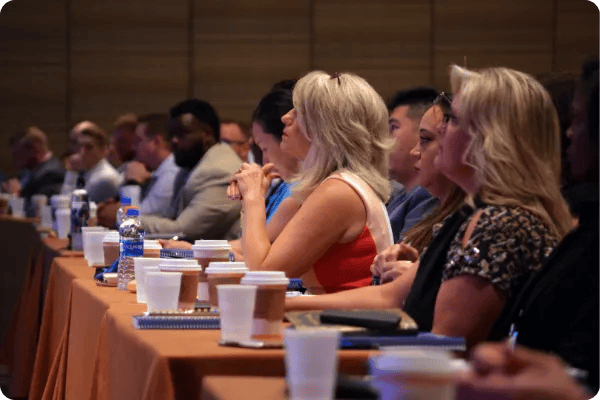 conference attendees listen to a keynote speaker at a seminar