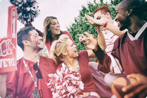 employees attend a sports game as a team bonding activity