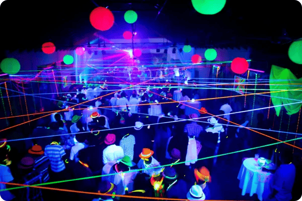 event attendees dance at a neon disco event at a conference