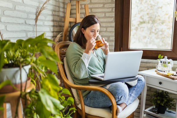 woman sitting in a chair drinking tea