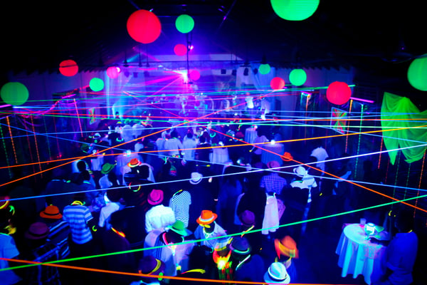 guests attend a neon party with glow in the dark costumes