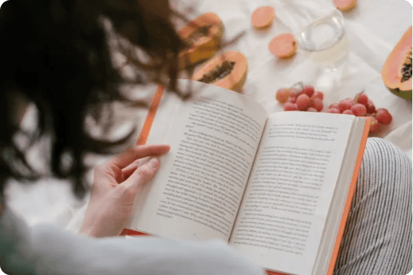 woman reads a book in bed