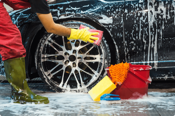 Athlete washes a car at a charity car wash