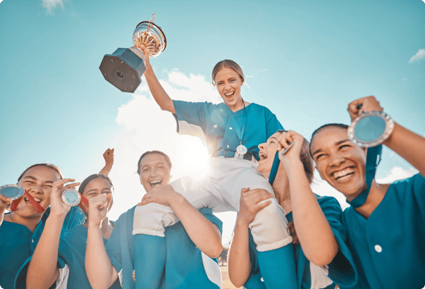 A team of young athletes hold up a trophy