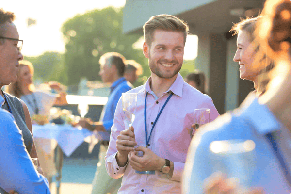 event attendees engage with one another during a happy hour