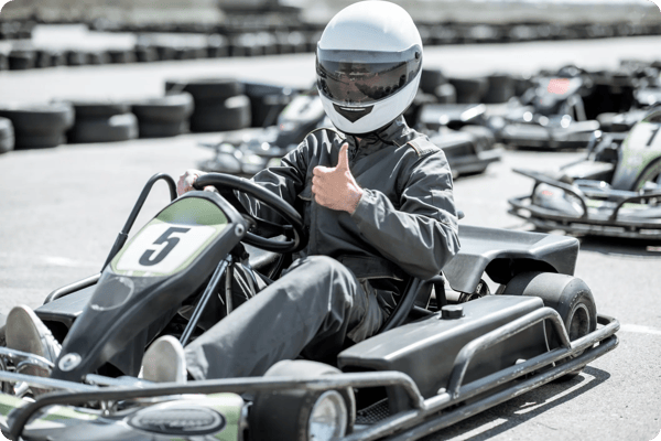 male employee gives a thumbs up from the go-kart track