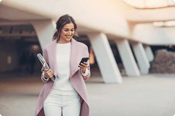 smiling business woman uses an event mobile app at a conference