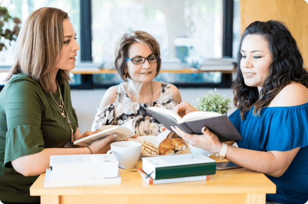 thee women meet for employee book club