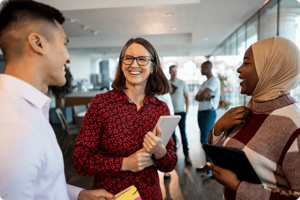 three diverse team members have a conversation at the office