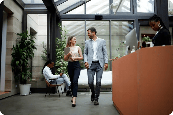 two event planners walk together in a LEED certified conference center building