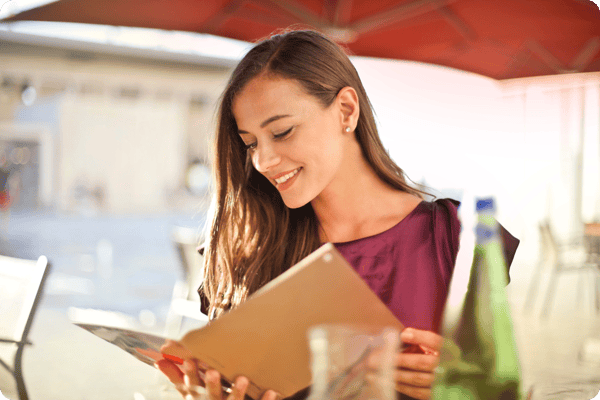 woman reads a professional development book outside