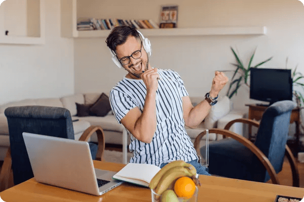 young male employee dances and sings during a virtual team party