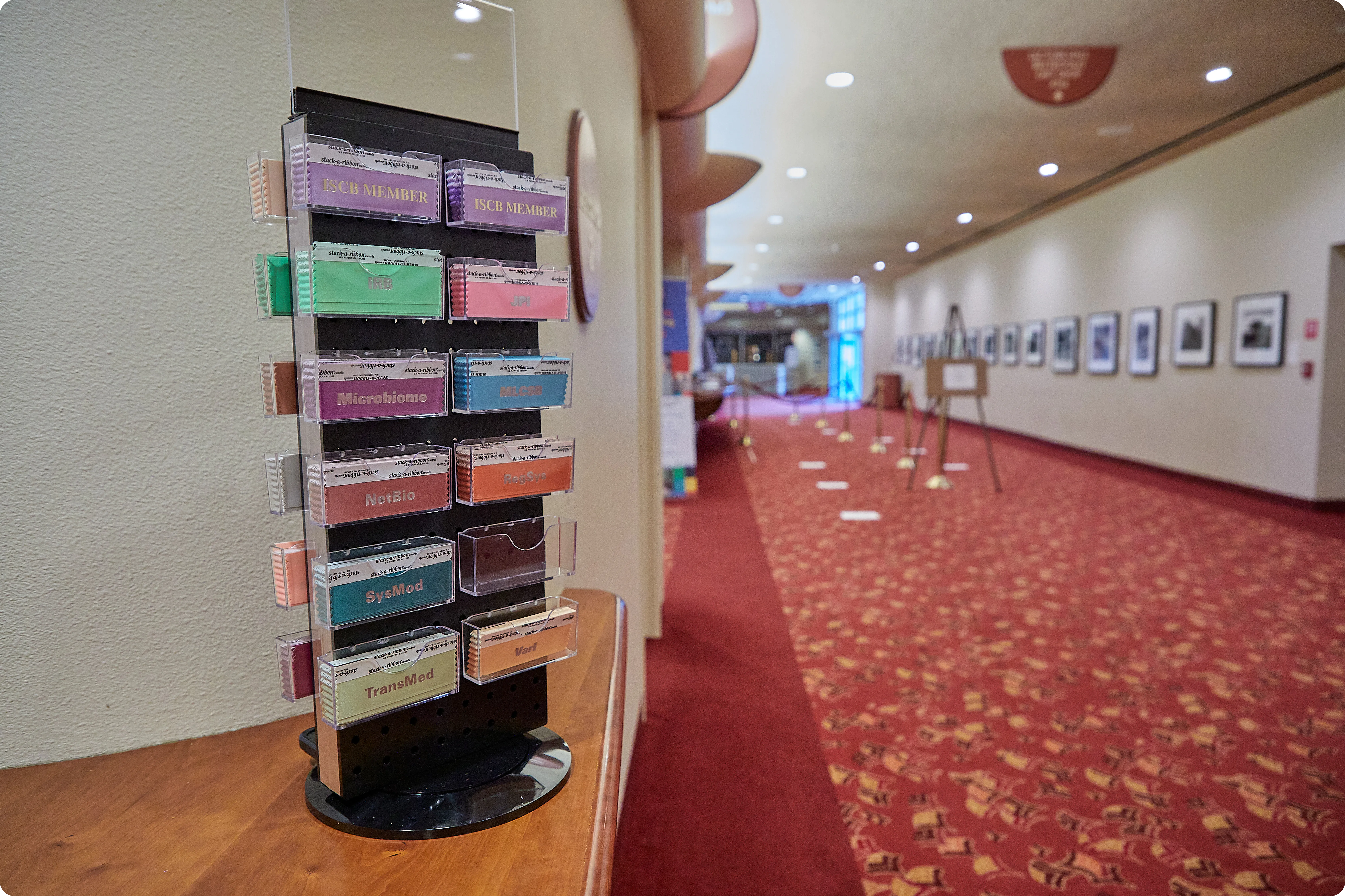 A colorful badge ribbon wall at ISMB 2022