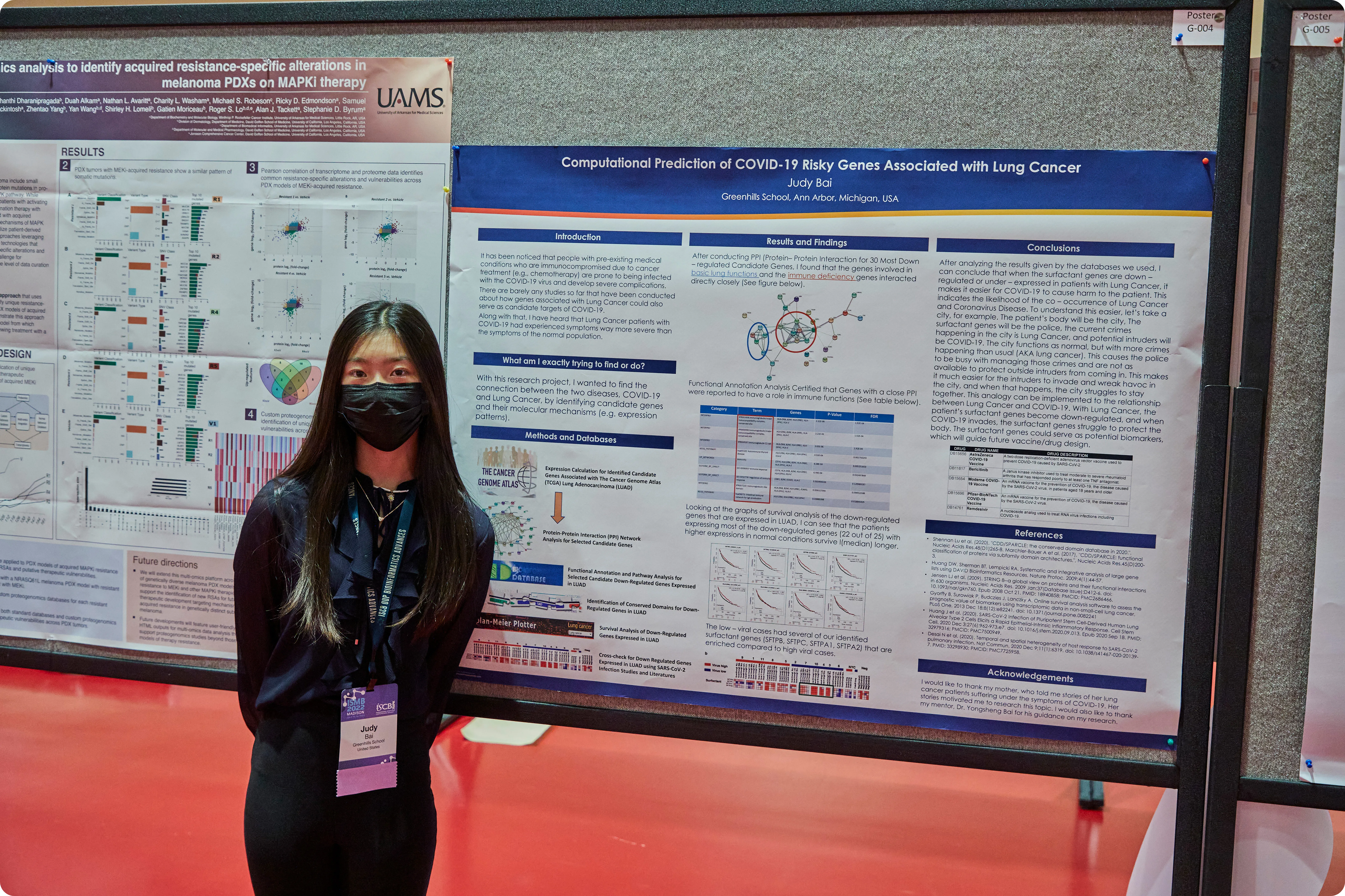 A young scientist presents her poster at ISMB 2022