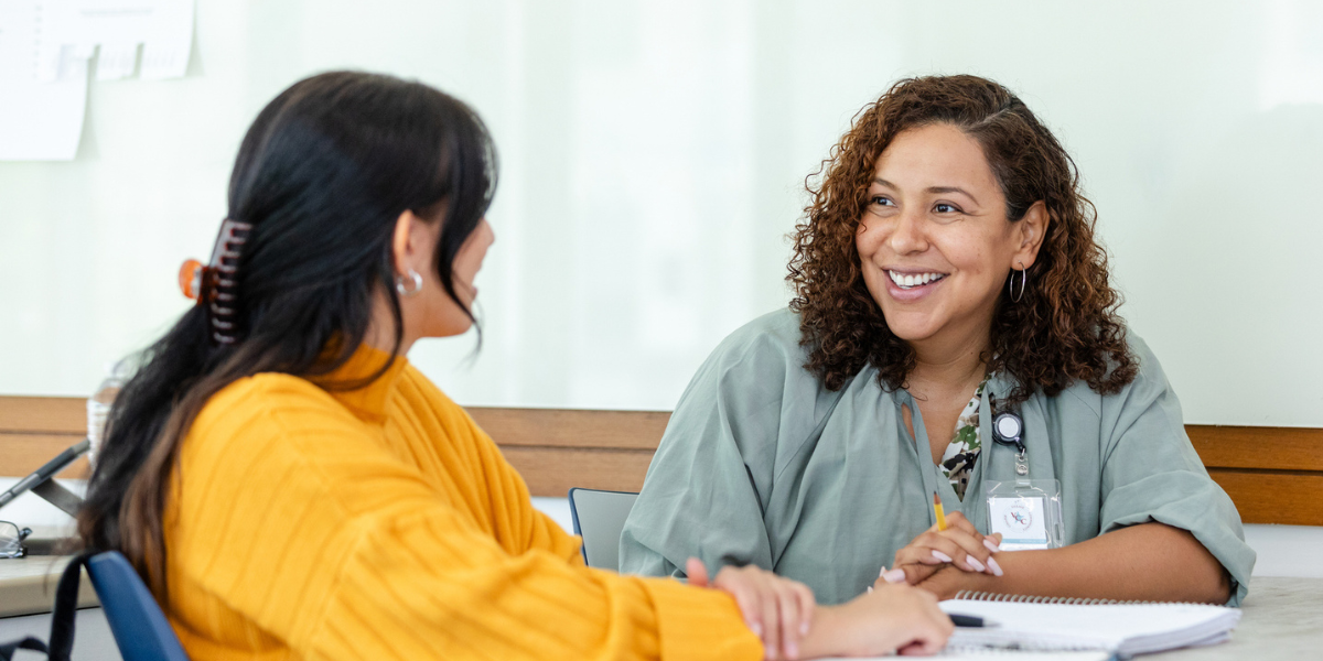 office employee explains the benefits of attending a conference to her boss