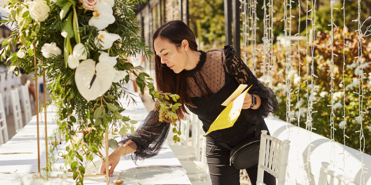 a wedding planner sets up a banquet table