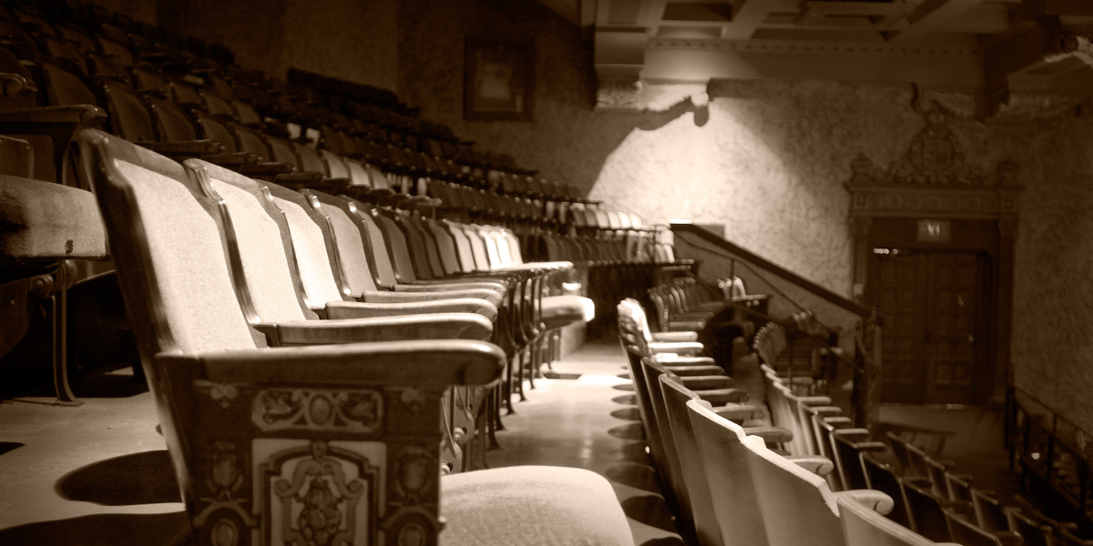 a darkened photo of old theatre seats