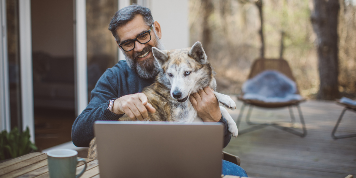 remote employee shows his dog on video during virtual coffee hour