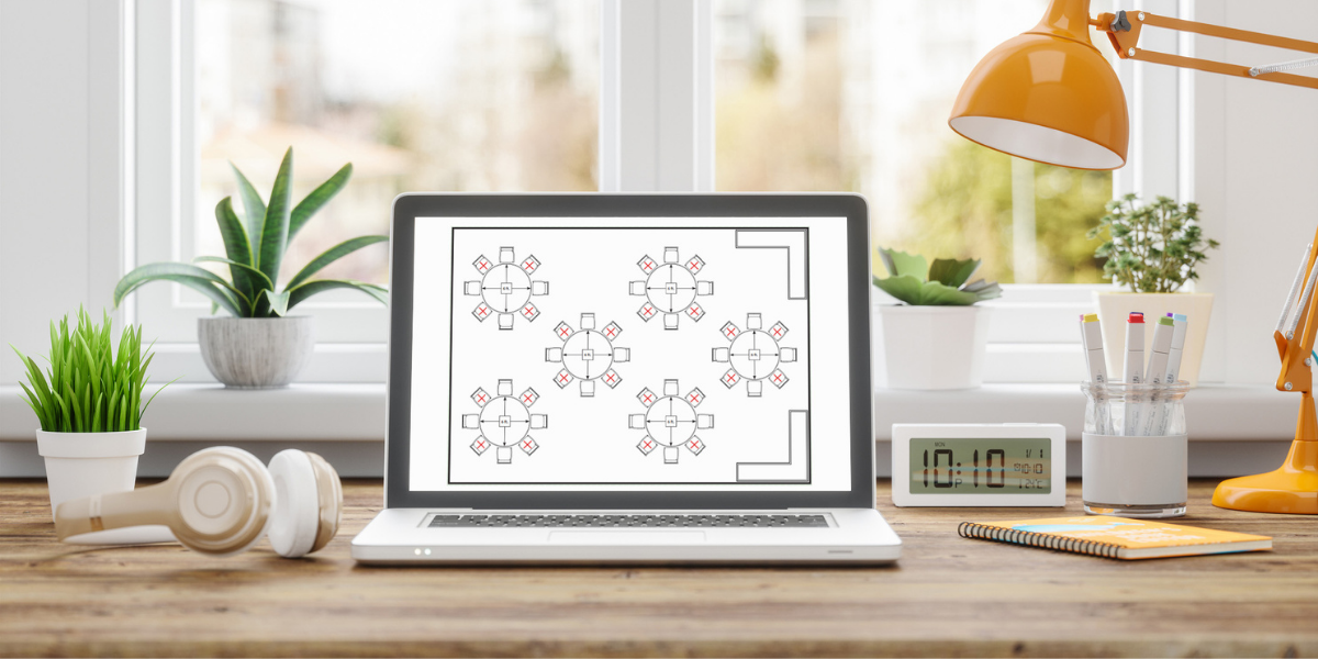 event planner's desk with floor planning software on screen