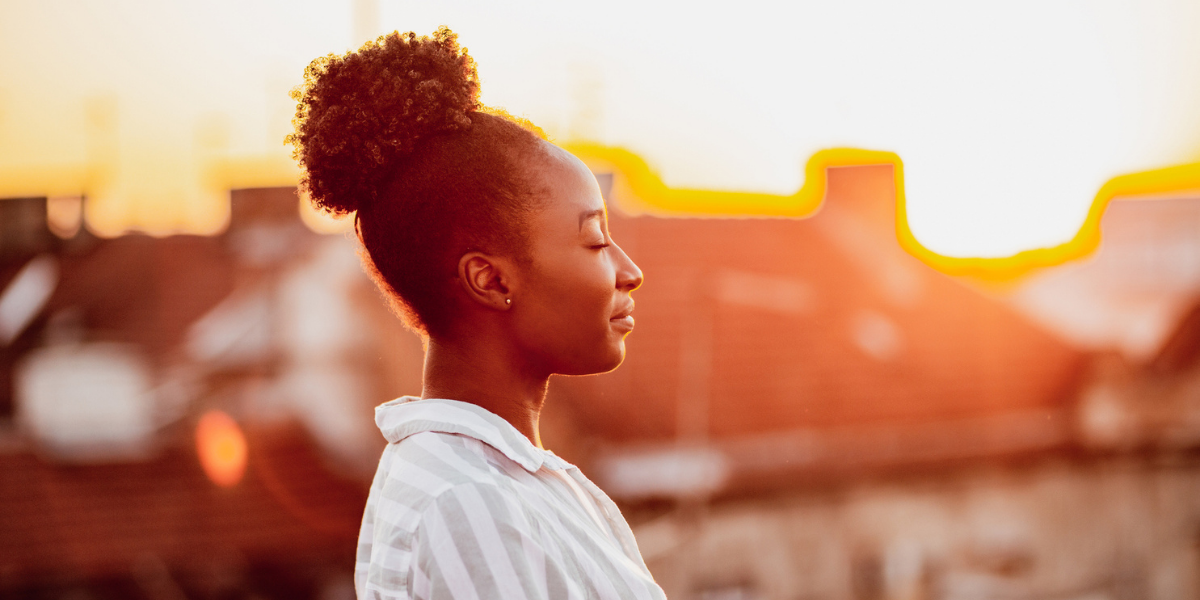 woman practices her self care routine outside