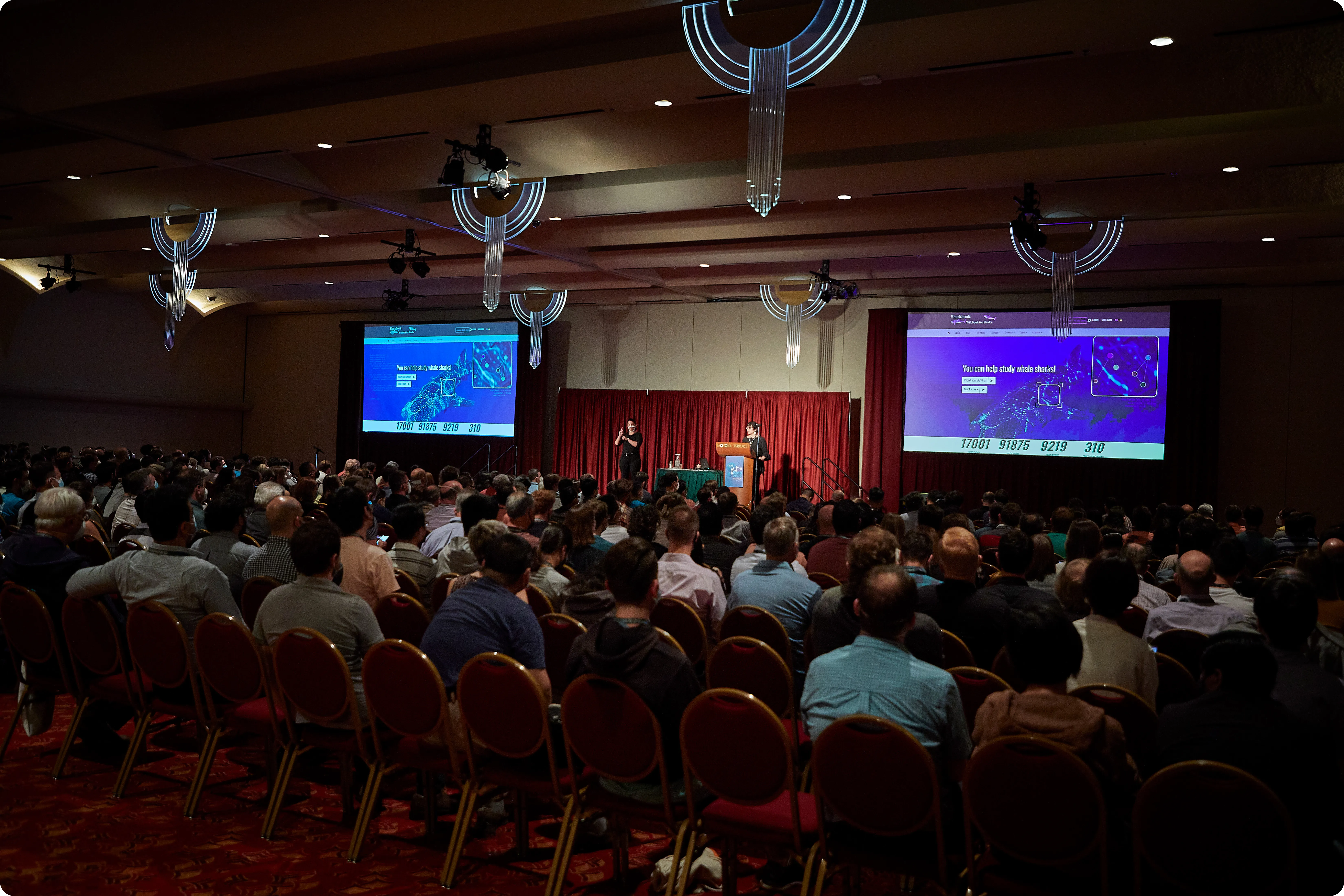 ISMB 2022 conference attendees listen to a breakout session