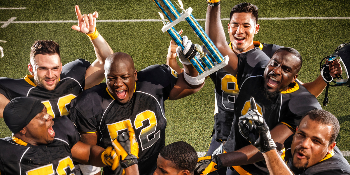 football team celebrates win with a trophy