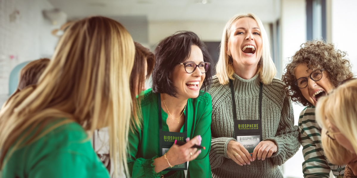 a group of female attendees wearing neck wallet badges