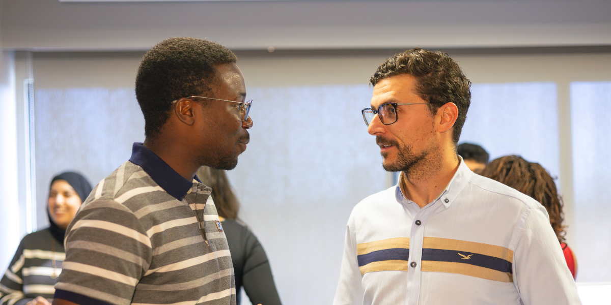 Two men holding cellphones participate in Jam Bingo by JamSocial