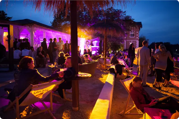 conference attendees outside on a beach at night at an all inclusive resort
