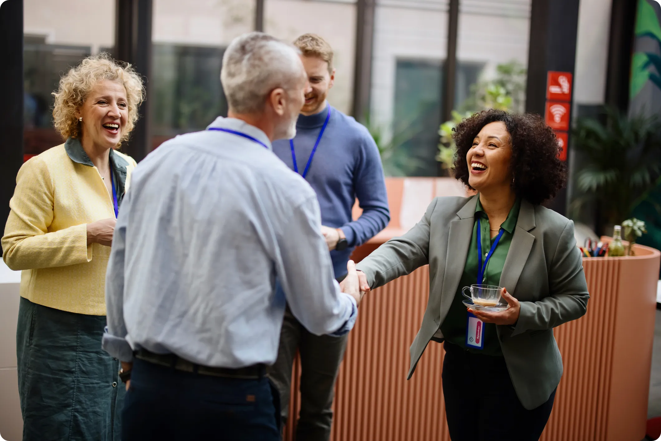 hospitality conference attendees shake hands at a social gathering