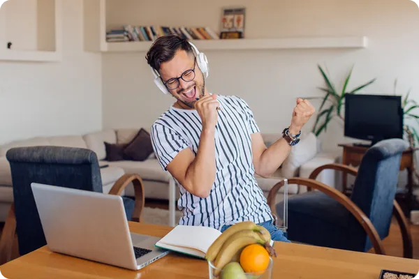 young male employee dances and sings during a virtual team party